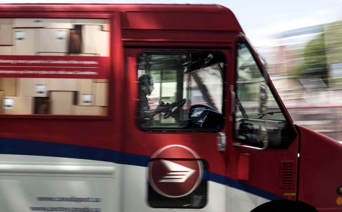 A Canada Post employee drives a mail truck through downtown Halifax on Wednesday, July 6, 2016. The union representing Canada Post employees has launched a new round of rotating strikes in Ontario and Newfoundland and Labrador.