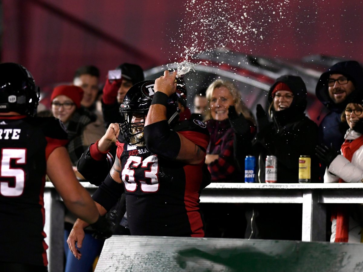 Ottawa Redblacks offensive lineman Jon Gott (63) smashes a beer can on his helmet after chugging it, as he celebrates his team's touchdown against the Toronto Argonauts during second half CFL football action in Ottawa on Friday, Nov. 2, 2018.