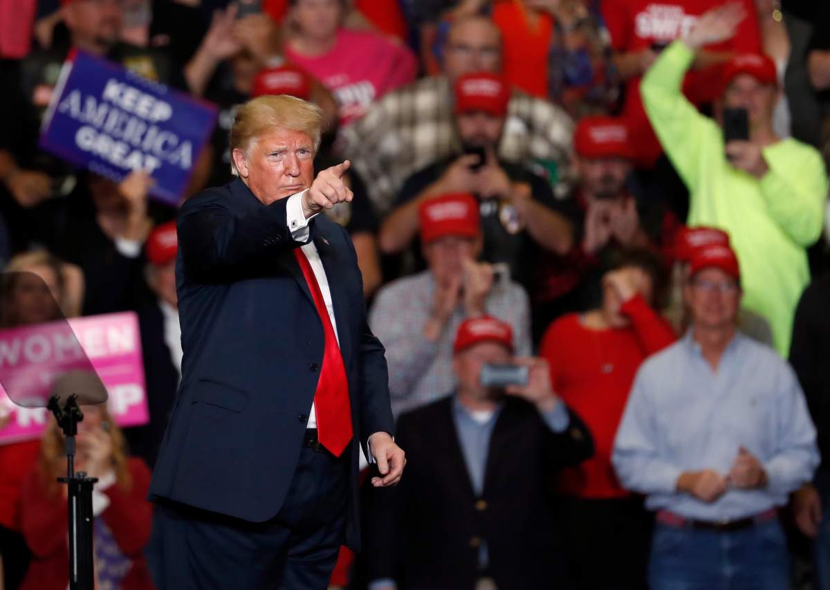 President Donald Trump points to the crowd as he leaves the stage at the end of a campaign rally Monday, Nov. 5, 2018, in Cape Girardeau, Mo.