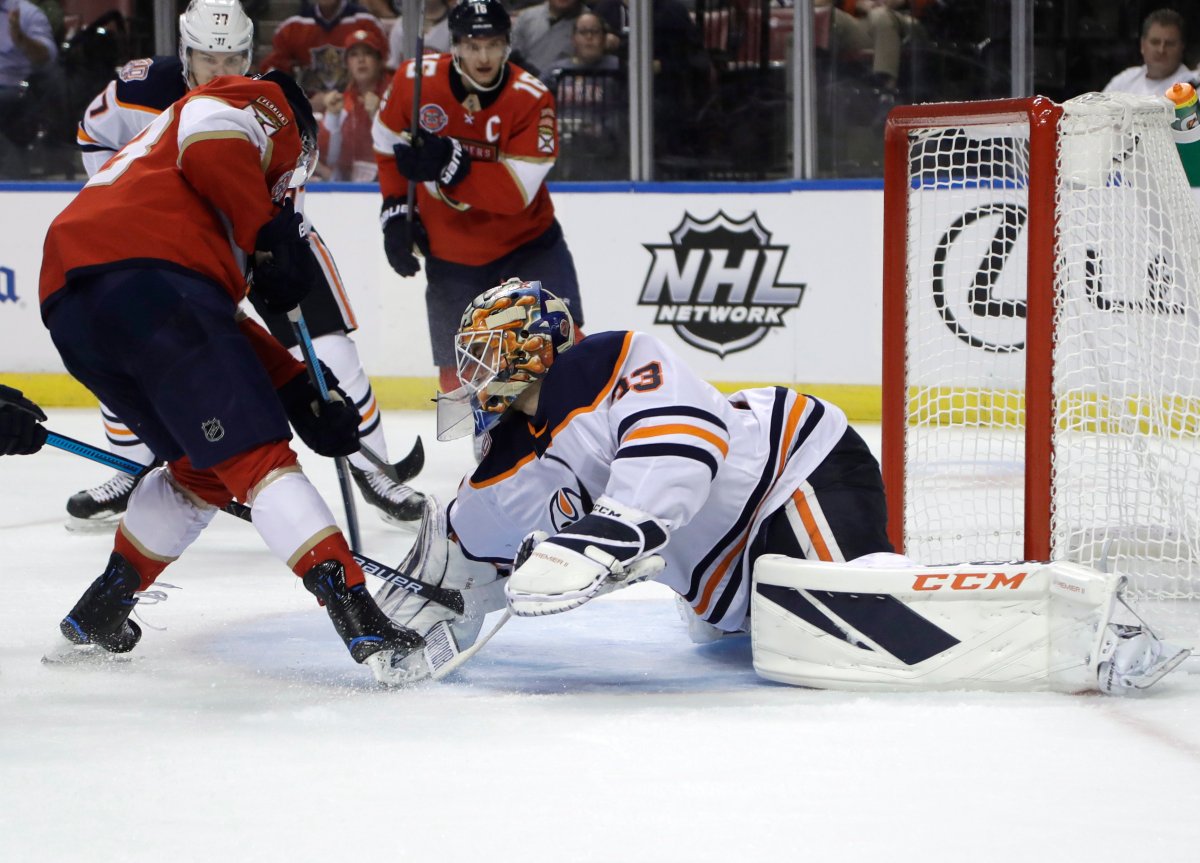Florida Panthers right wing Evgenii Dadonov, left scores a goal past Edmonton Oilers goaltender Cam Talbot (33) during the second period of an NHL hockey game, Thursday, Nov. 8, 2018, in Sunrise, Fla. (AP Photo/Lynne Sladky).