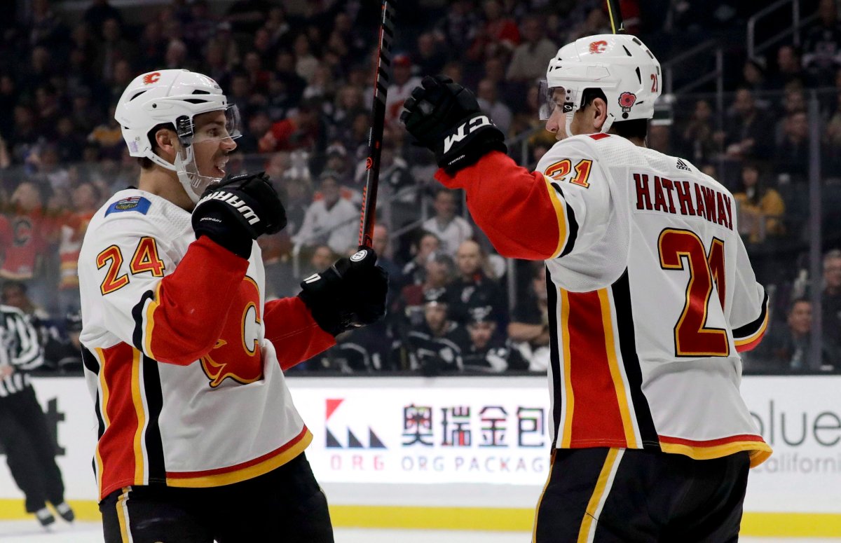 Calgary Flames defenseman Travis Hamonic, left, celebrates after scoring with right wing Garnet Hathaway during the first period of an NHL hockey game against the Los Angeles Kings in Los Angeles, Saturday, Nov. 10, 2018. 