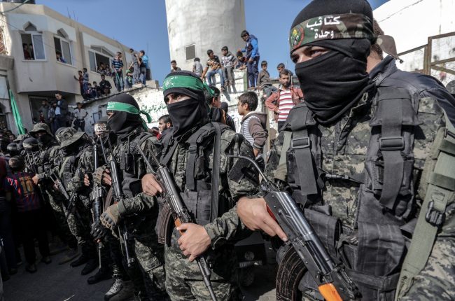 Fighters with Ezz al-Din Al-Qassam, the military wing of Hamas, attend the funeral of seven fighters in Khan Younis, southern Gaza Strip, Nov. 12, 2018.