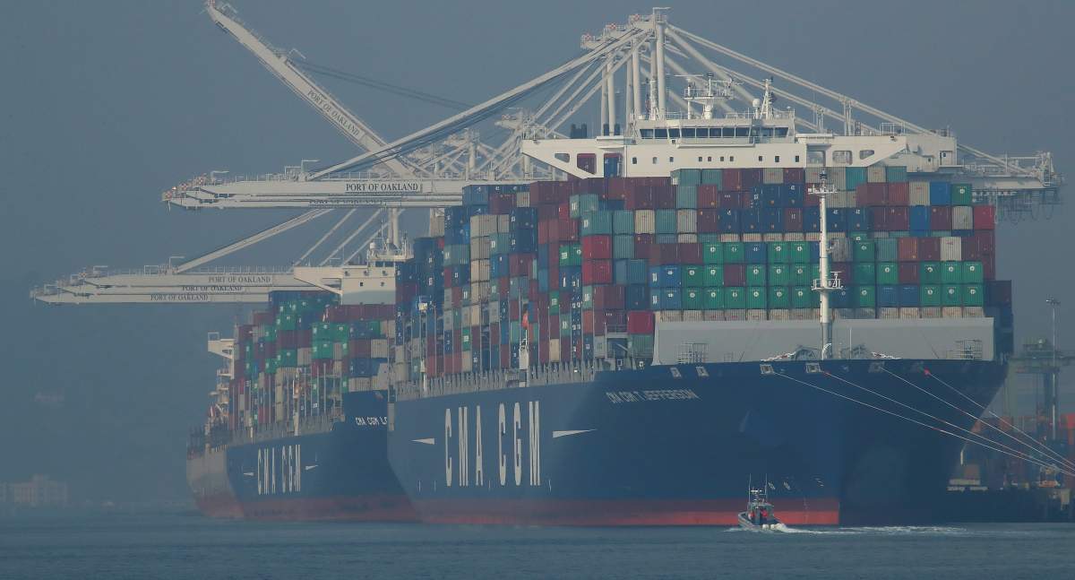 Container ships waiting to be unloaded are seen through a thick haze at the Port of Oakland on Wednesday, Nov. 14, 2018, in Oakland, Calif.