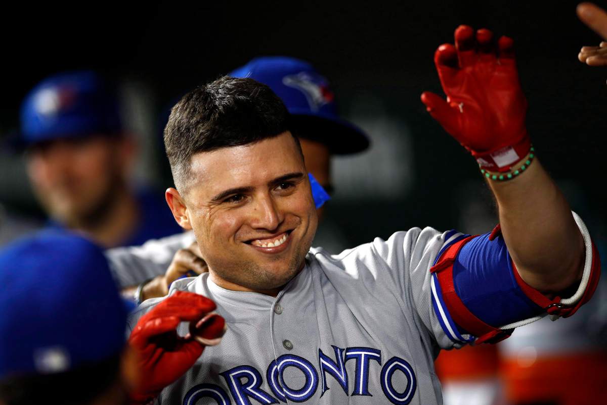 Toronto Blue Jays' Aledmys Diaz high-fives teammates in the dugout after hitting a solo home run in the ninth inning of a baseball game against the Baltimore Orioles in Baltimore on September 17, 2018. THE CANADIAN PRESS/AP, Patrick Semansky.