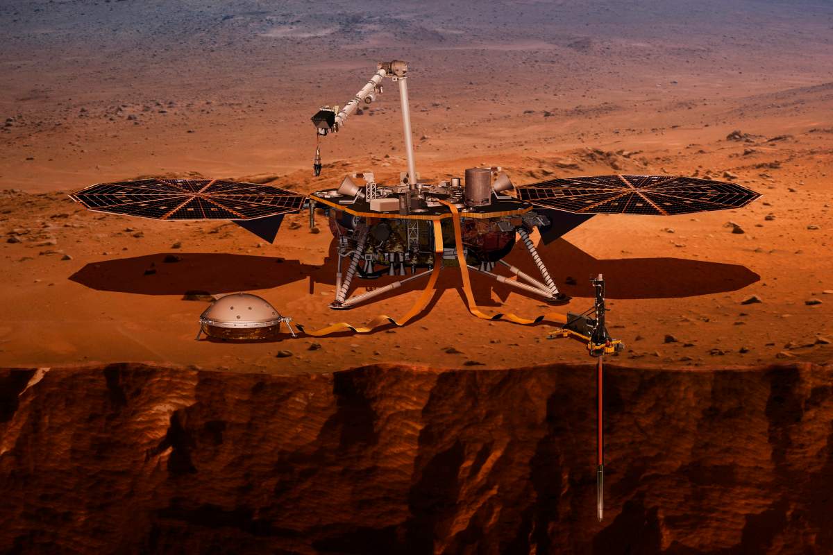 This illustration made available by NASA in 2018 shows the InSight lander drilling into the surface of Mars.