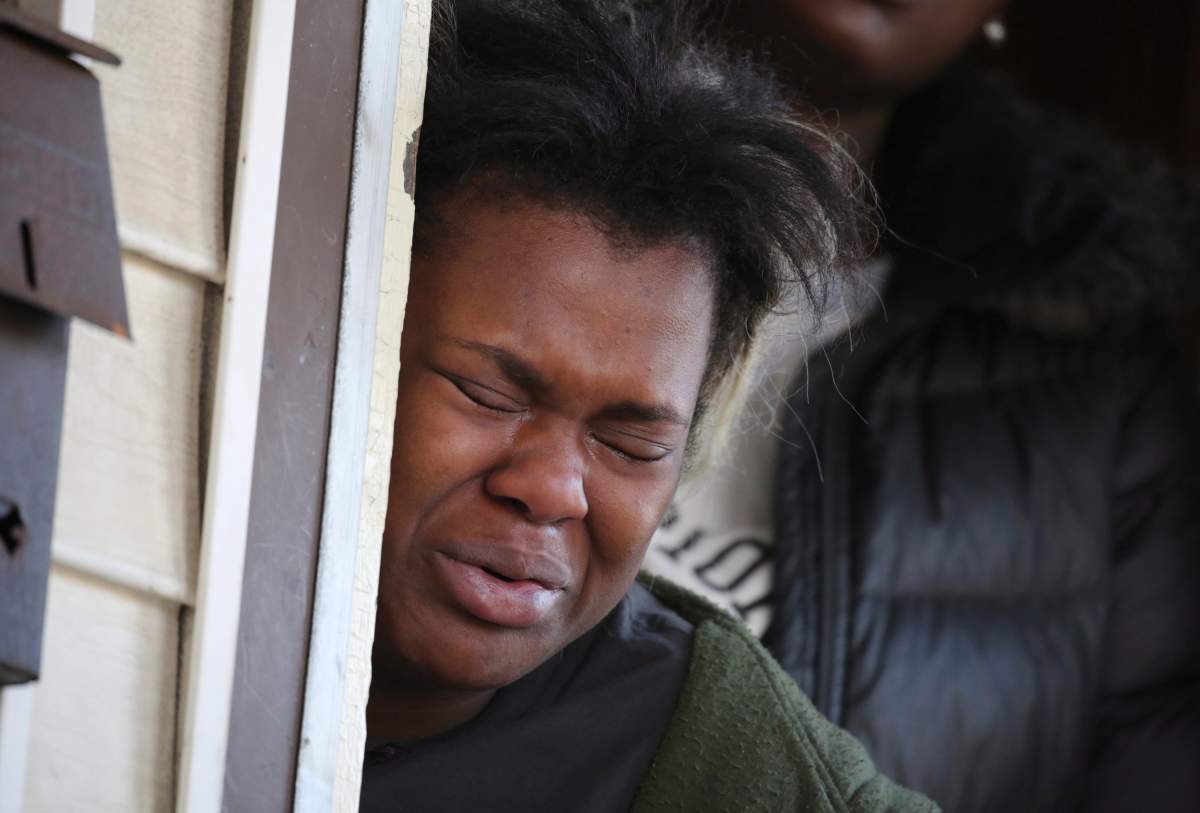 Tatiana Ingram, left, cries as others speak about her sister Sandra Parks, a 13-year-old girl who was killed in her bedroom when shots were fired the night before into her home in Milwaukee.