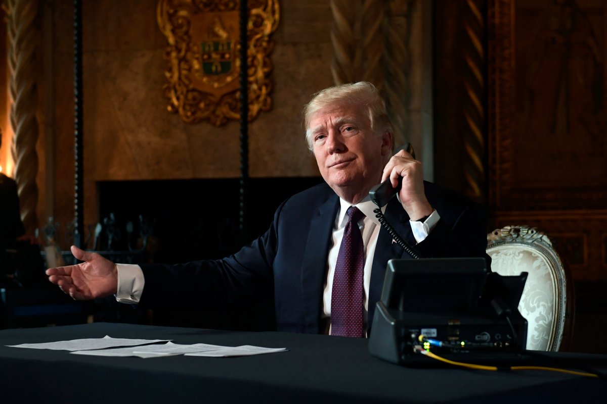 President Donald Trump asks if reporters can hear the audio as he talks with troops via teleconference from his Mar-a-Lago estate in Palm Beach, Fla., Thursday, Nov. 22, 2018.
