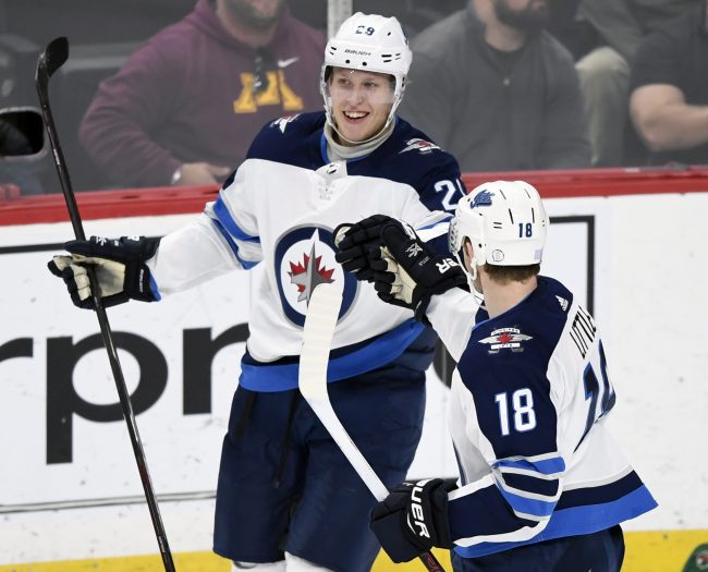 Winnipeg Jets' Bryan Little (18) congratulates right wing Patrik Laine (29), of Finland, on a goal against the Minnesota Wild during the first period of an NHL hockey game Friday, Nov. 23, 2018, in St. Paul, Minn.