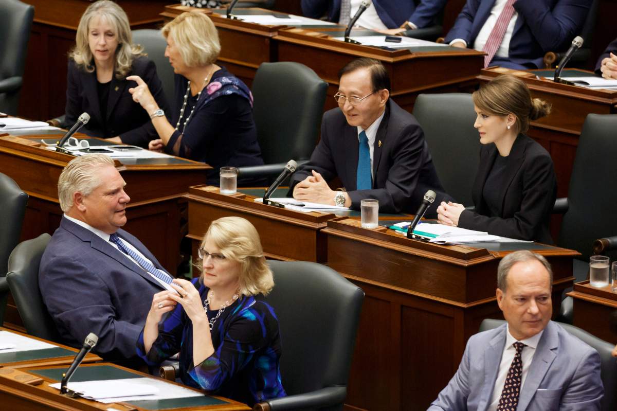 PC MPP Amanda Simard, second row right,  is seen seated amongst fellow MPP's and Ontario Premier Doug Ford, left, as the legislature sits inside Queens Park in Toronto  on Saturday, Sept. 15, 2018.