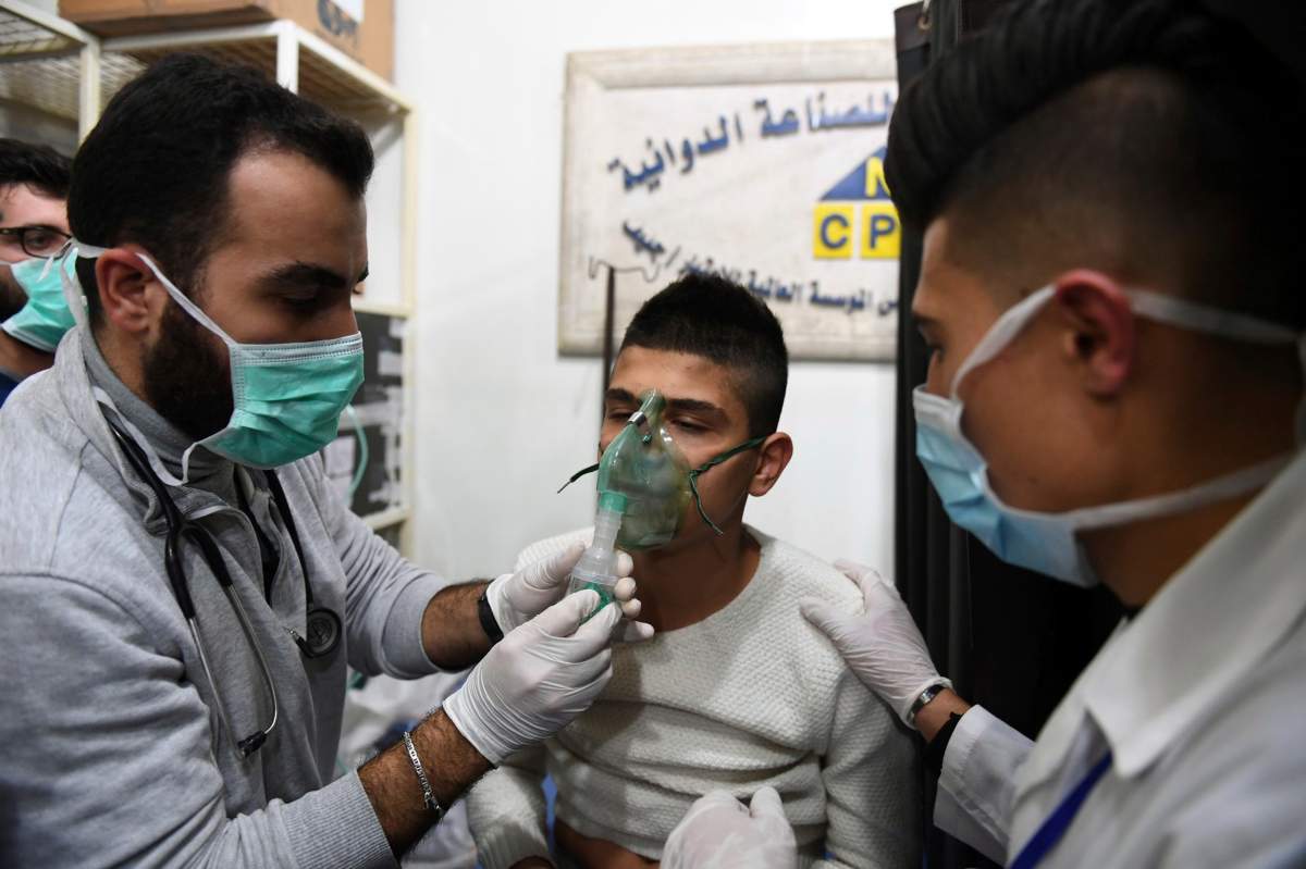 In this photo released by the Syrian official news agency SANA, shows a man receiving oxygen through respirators following a suspected chemical attack on his town of al-Khalidiya, in Aleppo, Syria, Saturday, Nov. 24, 2018.