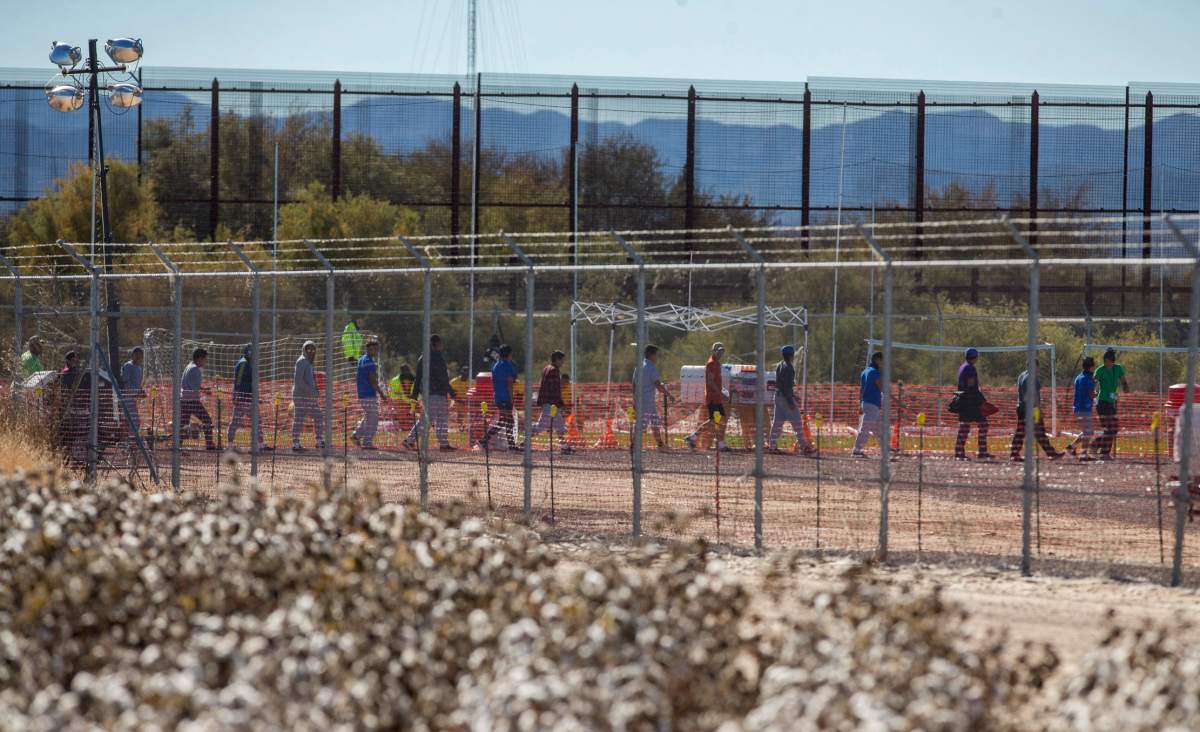 In this Nov. 15, 2018 photo provided by Ivan Pierre Aguirre, migrant teens are led in a line inside the Tornillo detention camp holding more than 2,300 migrant teens in Tornillo, Texas.