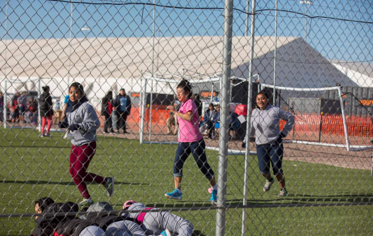 In this Nov. 25, 2018 photo provided by Ivan Pierre Aguirre, migrant teens held inside the Tornillo detention camp run at the facility in Tornillo, Texas.
