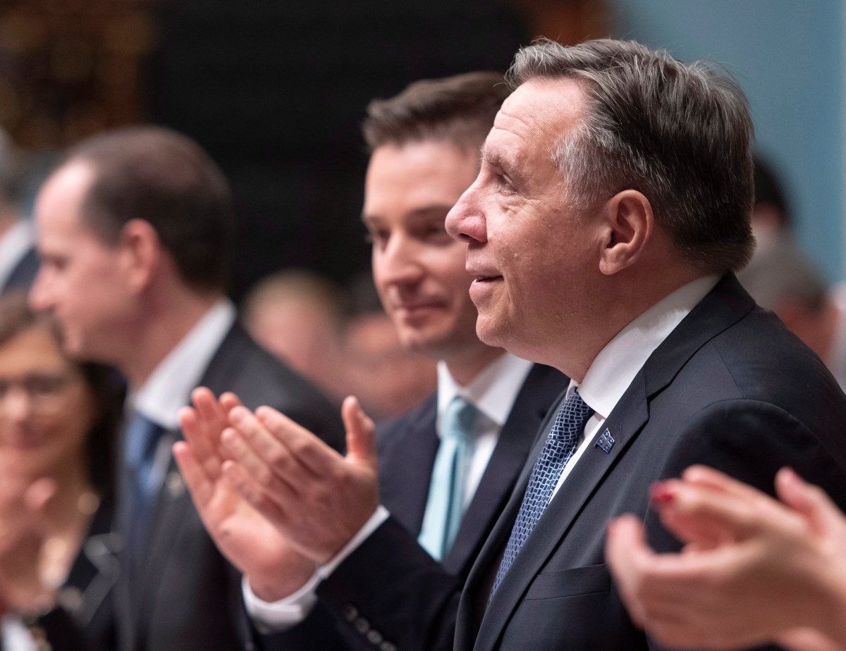 Quebec Premier François Legault, right, is applauded by his caucus during the inaugural speech, Wednesday, November 28, 2018 at the legislature in Quebec City. THE CANADIAN PRESS/Jacques Boissinot.