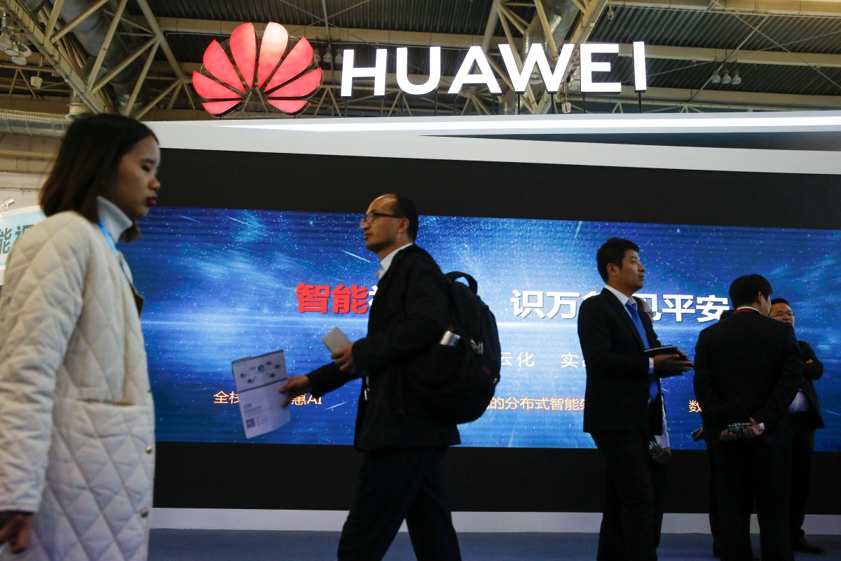 People walk past the stall of the telecommunications equipment maker Huawei Technologies at the Security China 2018 exhibition on public safety and security in Beijing, China, Oct. 23, 2018.


