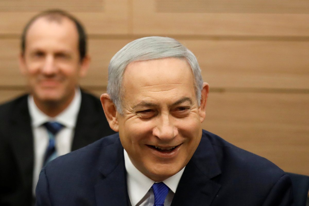 Israeli Prime Minister Benjamin Netanyahu smiles as he attends the Foreign Affairs and Defense Committee at the Knesset, Israel's Parliament, in Jerusalem November 19, 2018. 