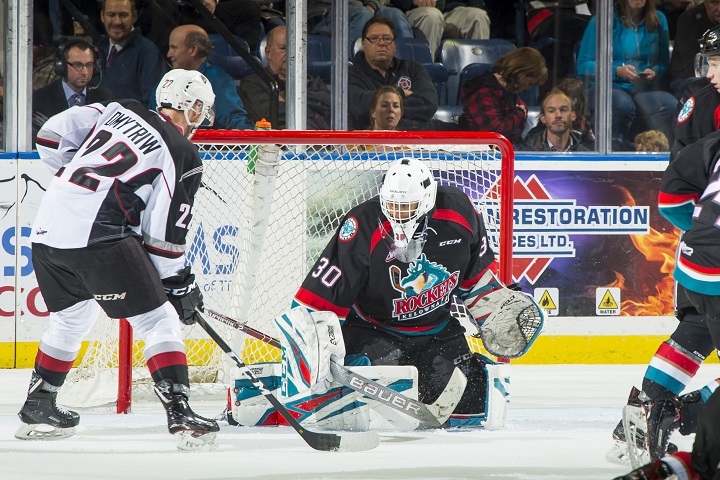 Jared Dmytriw of the Vancouver Giants, left, tries to put the puck past Kelowna Rockets goaltender Roman Basran during WHL action at Prospera Place on October 3rd. Vancouver won 5-0.