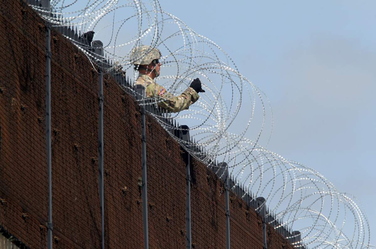 U.S. Army soldiers install a barbed wire fence along Anzalduas International Bridge near the U.S.-Mexico border in McAllen, Texas, Nov. 5, 2018.