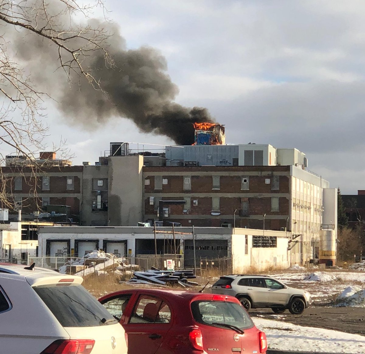Flames and heavy smoke can be seen coming from the roof of the former McCormick-Beta Brands factory in east London, Nov. 20, 2018.