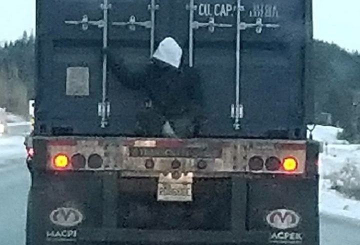 Emile Clavel couldn't believe his eyes as he drove to work along a busy highway in Quebec's Saguenay-Lac-Saint-Jean region Wednesday morning. As he approached a transport truck about 250 kilometres north of Quebec City, he noticed a man perched on the back. 