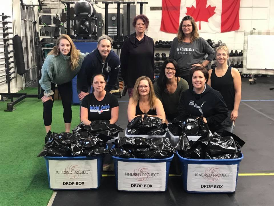 Members of the Kindred Project at ShopGym Inc. in Niverville, Man., packing 100 feminine hygiene packs to be included in the Bannock and Backpacks campaign.