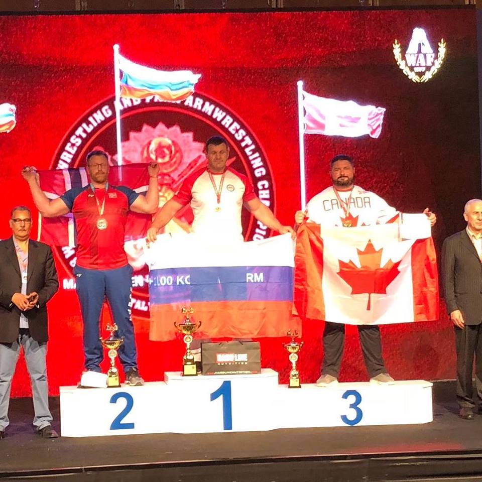 Ryan Espey, right, poses after his bronze medal win at the 2018 World Armwrestling Championship.
