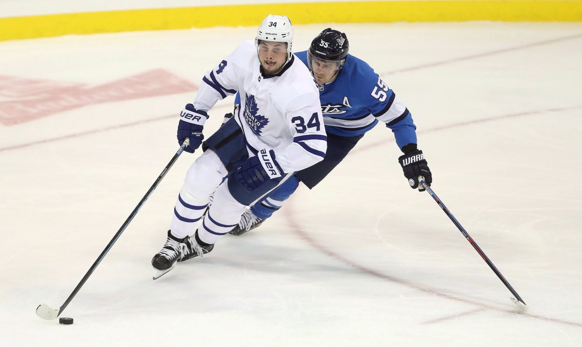 Toronto Maple Leafs' Auston Matthews (34) and Winnipeg Jets' Mark Scheifele (55) during first period NHL hockey action in Winnipeg, Wednesday, Oct. 24, 2018.