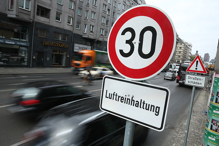 Cars drive past a speed limit sign in Berlin, Germany. 