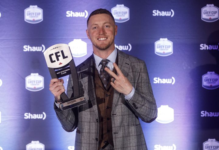 Winner of Most Outstanding Player, Calgary Stampeders quarterback Bo Levi Mitchell, holds his award during the Shaw CFL Awards in Edmonton on Thursday, Nov. 22, 2018. 