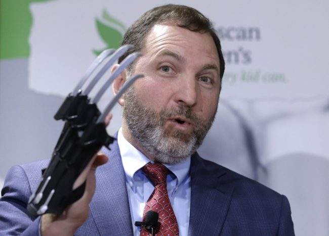 James Schwartz, director of World Against Toys Causing Harm, or W.A.T.C.H., displays a Black Panther "slash claw." in Boston, Nov. 13, 2018. The group says the "slash claw" has the potential to cause eye and facial injuries.