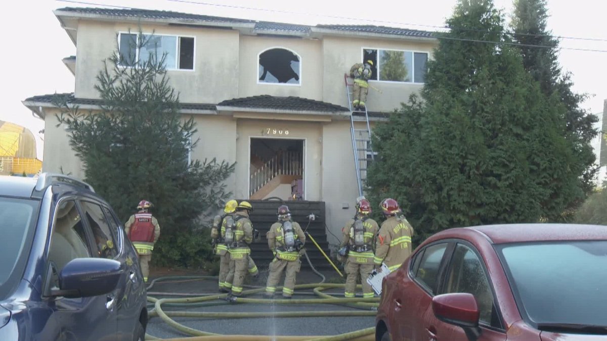 Crews extinguish a fire at a Burnaby home on Nov. 17, 2018.