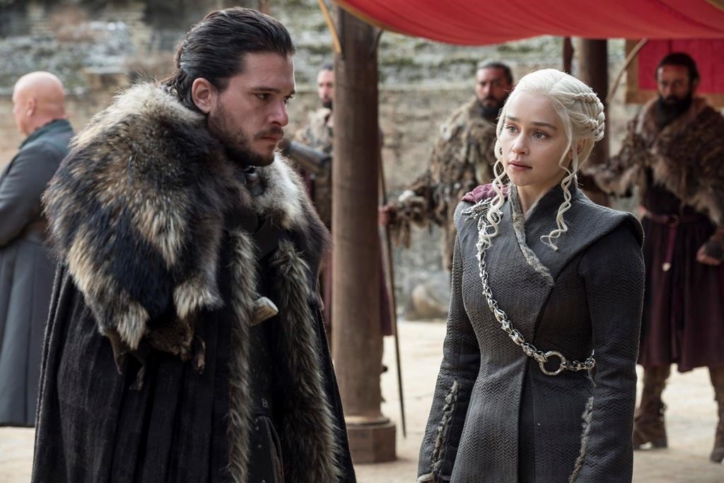 This image released by HBO shows Kit Harington, left, and Emilia Clarke on the season finale of 'Game of Thrones.'.