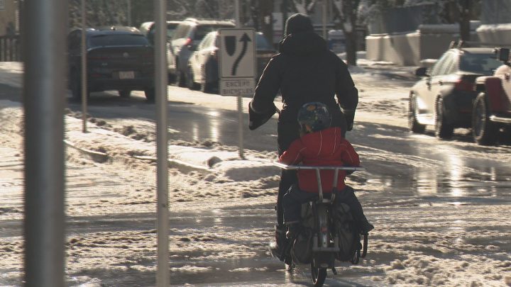 Natalie Sit rode with her daughter in tow through Eau Claire on Sunday morning.