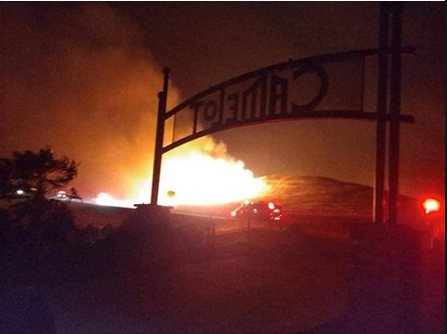 A fire rages in the background at Camelot Equestrian Park.