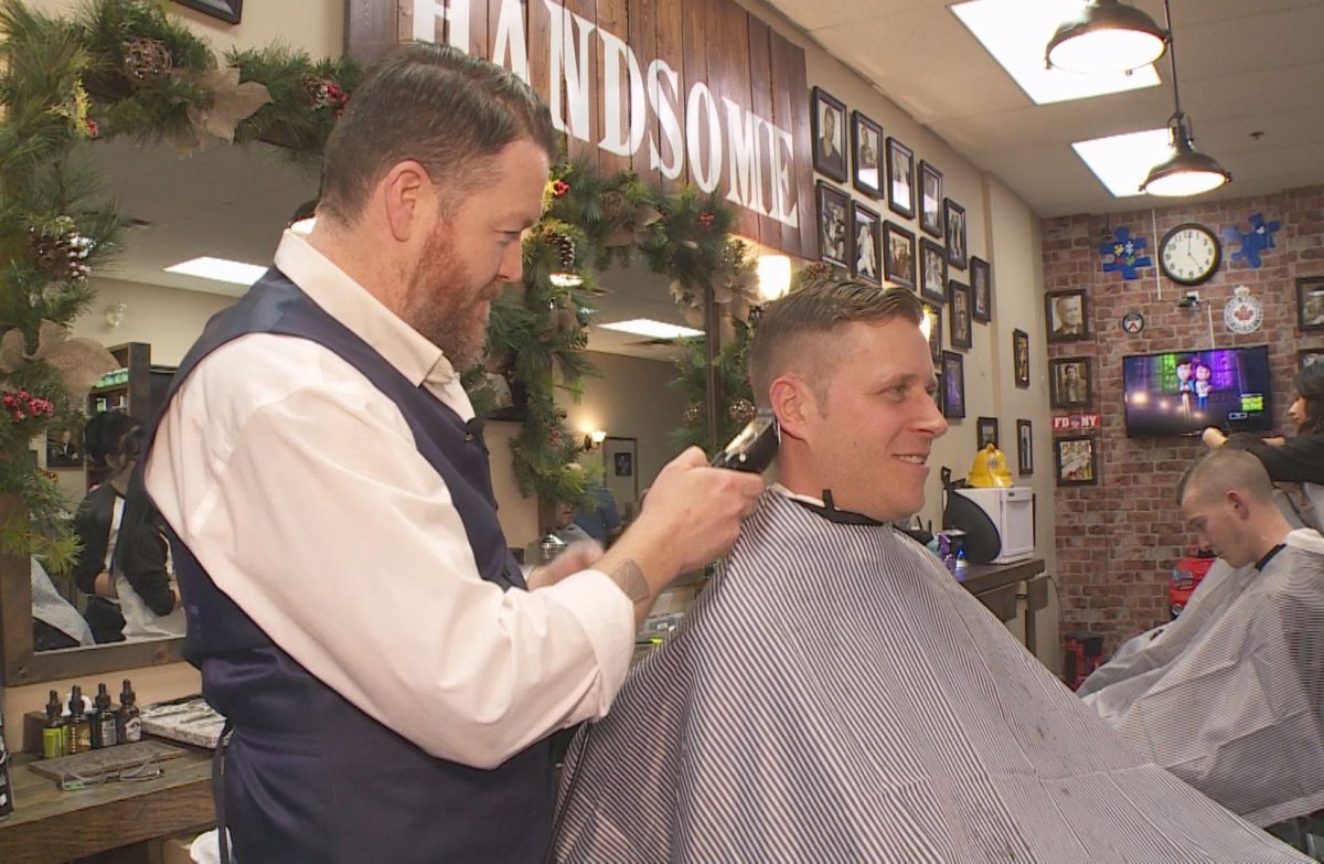 Steven Grimley (left), the co-owner of The Kingsmen barbershop in Courtice, Ont., cuts Jos Diening's hair on Nov. 14. Grimley will be donating a dollar from this cut, as well as every other service done at the shop this month, to the Movember Foundation. 