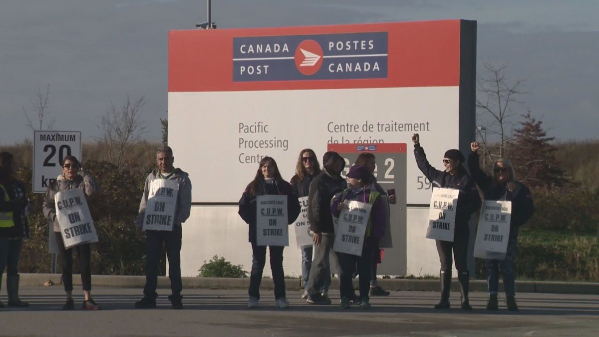 Canada Post workers picket outside a Richmond sorting facility on Saturday, Nov. 10. 