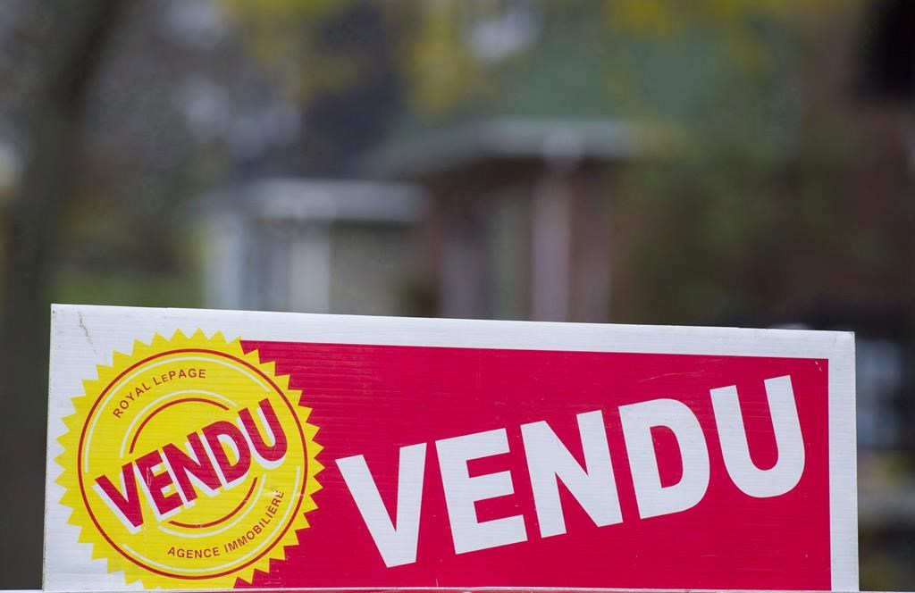 A sign meaning sold is shown on the west island of Montreal, Saturday, November 4, 2017. Home sales across Montreal and its surrounding areas in October surged 11 per cent compared with a year ago, as the city's real estate market continued on a hot streak. THE CANADIAN PRESS/Graham Hughes.
