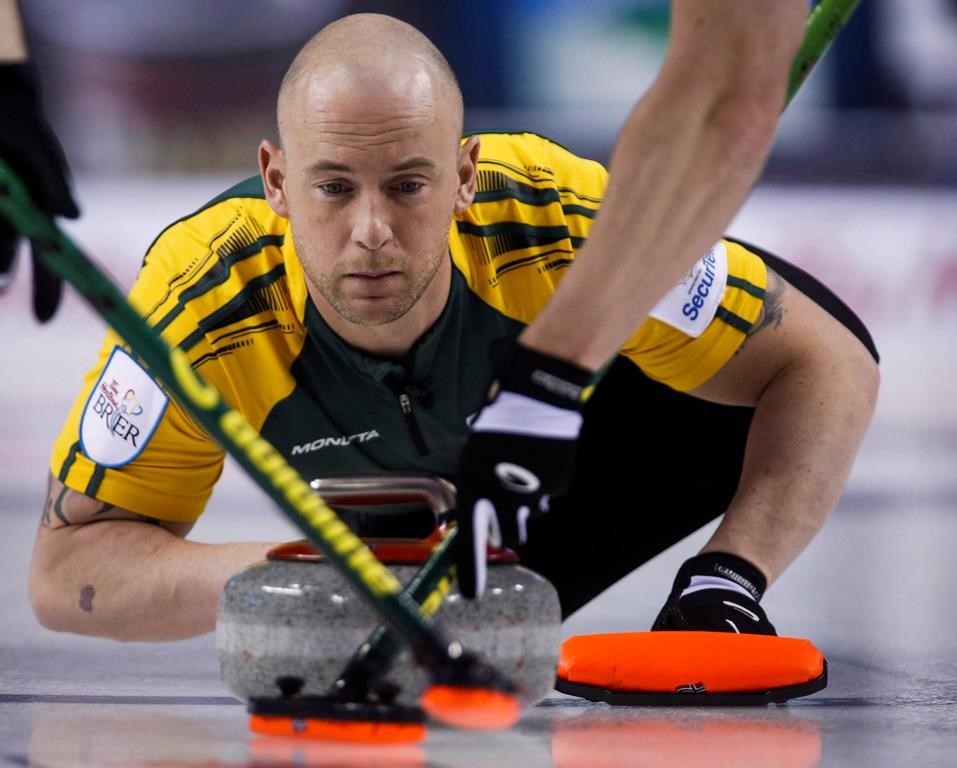 Northern Ontario third Ryan Fry makes a shot as his team plays Newfoundland and Labrador during curling action at the Brier in Calgary, Thursday, March 5, 2015. THE CANADIAN PRESS/Jeff McIntosh.