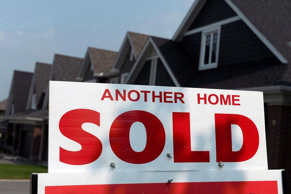A for sale sign displays a sold home in a development on July 6, 2015. 