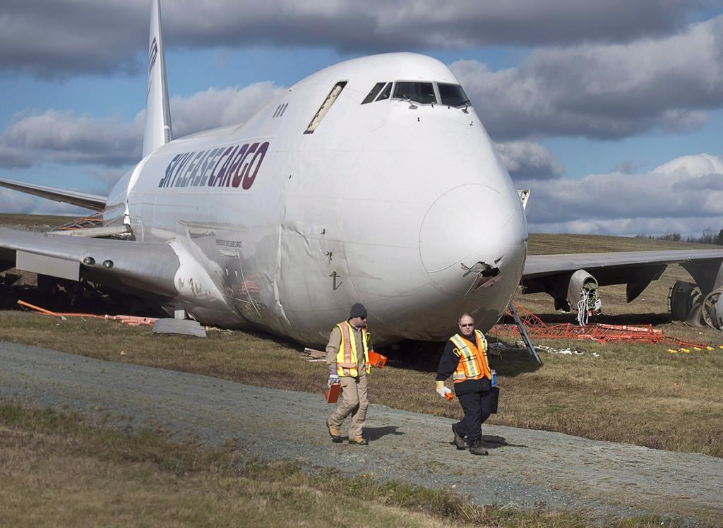 Transportation Safety Board investigators remove flight data recording equipment from a SkyLease Cargo plane at Halifax Stanfield International Airport, on Thursday, Nov. 8, 2018.