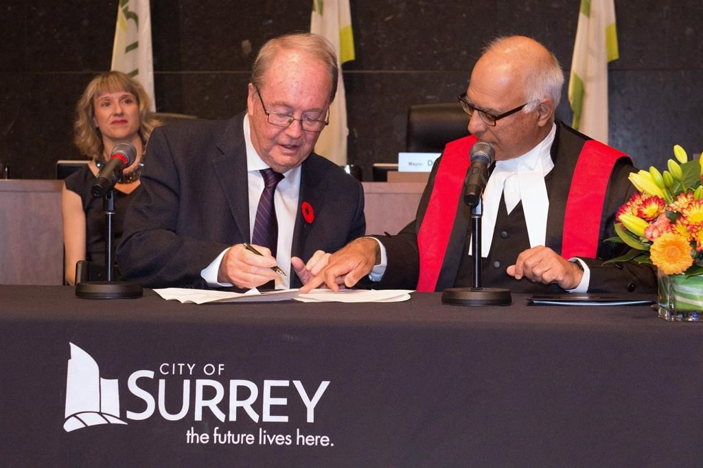 Surrey Mayor Doug McCallum, left, is sworn in during an inauguration ceremony in Surrey, B.C. on Monday, November 5, 2018 in this handout photo. THE CANADIAN PRESS/HO, Brian Dennehy, City of Surrey *MANDATORY CREDIT*.