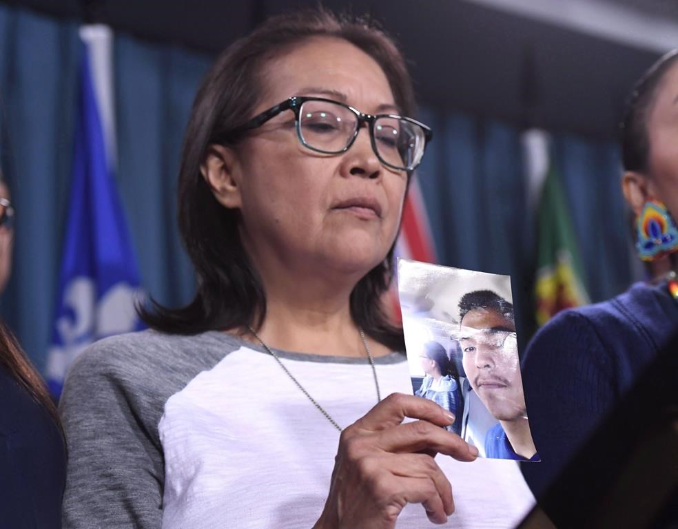 Debbie Baptiste, mother of Colten Boushie, holds a photo of her son during a press conference on Parliament Hill in Ottawa on February 14, 2018. The Saskatchewan throne speech last month included a reference to changing trespassing laws to "better address the appropriate balance between the rights of rural landowners and members of the public." The province has already sought public input on whether access to rural property should require prior permission from a landowner, regardless of the activity, and if not doing so should be illegal. A lawyer representing the family of Colten Boushie, an Indigenous man fatally shot by farmer Gerald Stanley in August 2016, said she is worried the Saskatchewan Party government is engaged in political posturing which could stoke racial fear. THE CANADIAN PRESS/Justin Tang.