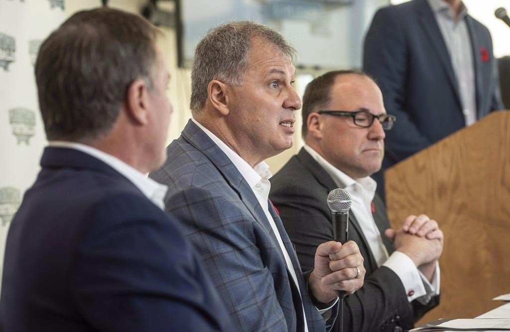 CFL commissioner Randy Ambrosie, centre, speaks to reporters during a press conference with Maritime Football Limited Partnership founding partners Bruce Bowser, left, and Anthony LeBlanc in Halifax on Wednesday, Nov. 7, 2018.