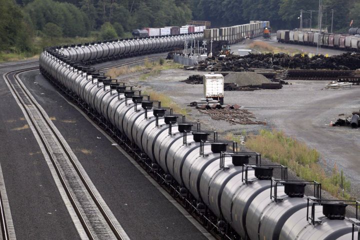 The National Energy Board says crude-by-rail exports from Canada rose to a record 269,829 barrels per day in September. A northbound oil train sits idled on tracks, stopped by protesters blocking the track ahead, in Everett, Wash., on September 2, 2014. 