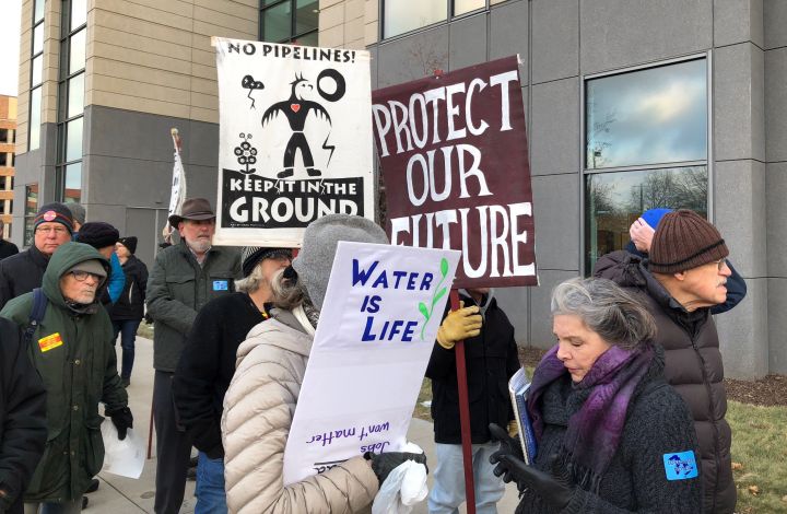 Opponents of Enbridge's proposed Line 3 crude oil pipeline line up for a Minnesota Public Utilities Commission hearing on the project on Monday, Nov. 19, 2018, in St. Paul, Minn.