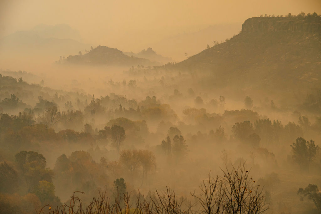 PARADISE, CA – NOVEMBER 11: Smoke lingers through the valley near Skyway in Chico, California on November 11, 2018. Camp Fire is at 109,000 acres with 25% contained and is the third-deadliest wildfire on record in California. As of Sunday morning, the death toll at 23. (Photo by Mason Trinca for The Washington Post via Getty Images)