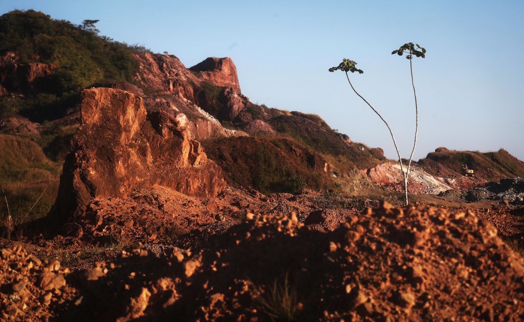 Amazon soil sits in the foreground at the Bom Futuro open air tin mine, one of the largest tin mines in the world, in a deforested section of the Amazon rainforest on June 27, 2017 in Bom Futuro, Brazil.