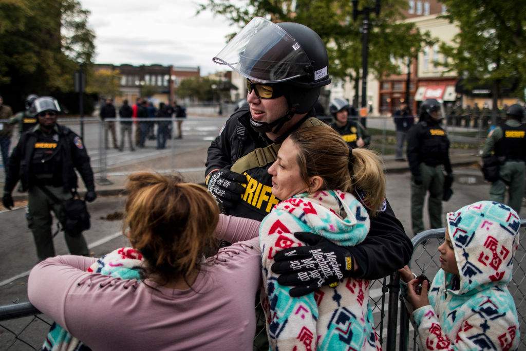 Krystal Dunnaway of Nashville hugs an officer after a White Lives Matter rally on October 28, 2017 in Murfreesboro, Tennessee. 



