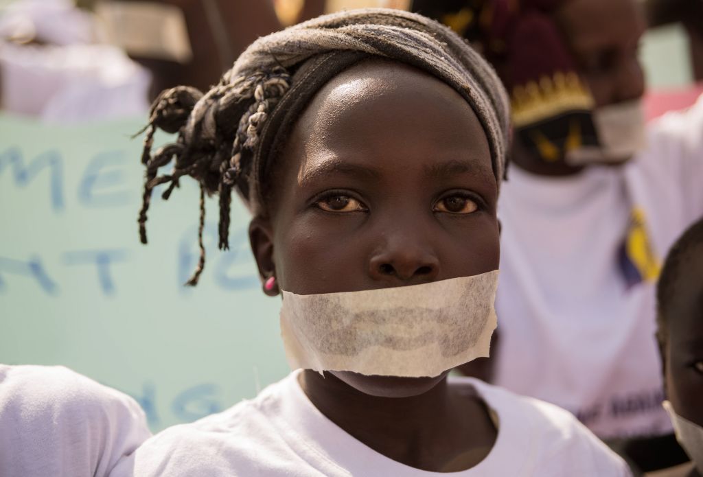A girl wears tape over her mouth during a protest by Sudanese women's organizations against the suffering faced by women and children, Juba, South Sudan, Dec. 9, 2017.




