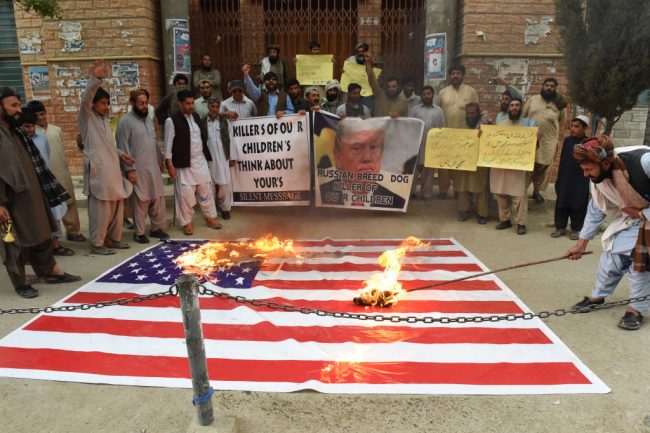 Pakistani protesters burn a U.S. flag during a protest against a U.S. airstrikeduring a demonstration against a US airstrike in Afghanistan in Quetta on April 3, 2018.