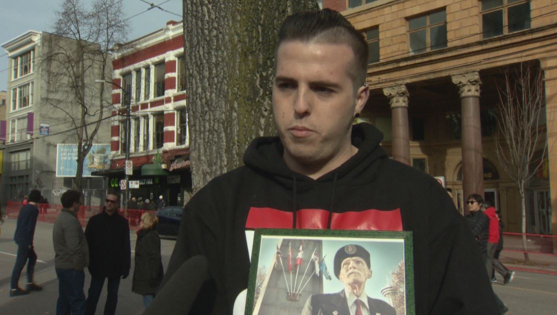 Markus McNeilly with a photo of his grandfather Art Leggett.